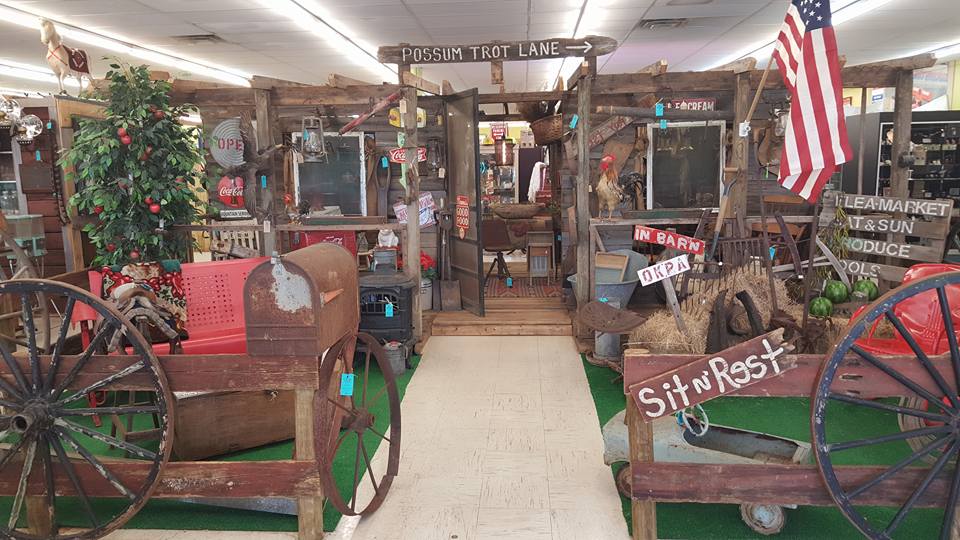 The main aisle of Ocala Antique Mall with rows of dealer booths stretching into the distance